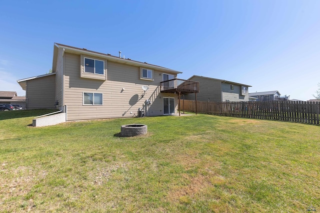 573 Plover Dr, Box Elder, SD 57719 - back of house with an outdoor fire pit and a wooden deck
