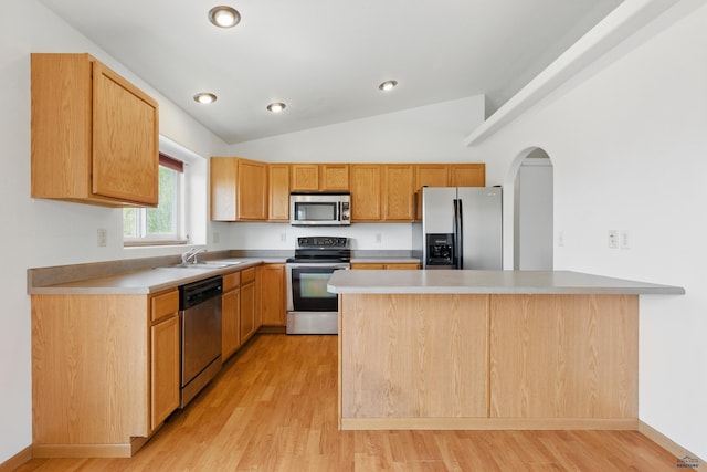 573 Plover Dr, Box Elder, SD 57719 - kitchen featuring appliances with stainless steel finishes, light wood finished floors, a peninsula, light countertops, and vaulted ceiling