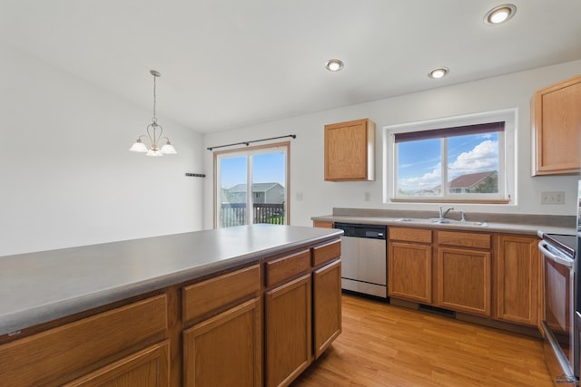 573 Plover Dr, Box Elder, SD 57719 - kitchen with appliances with stainless steel finishes, a sink, light wood finished floors, decorative light fixtures, and a chandelier