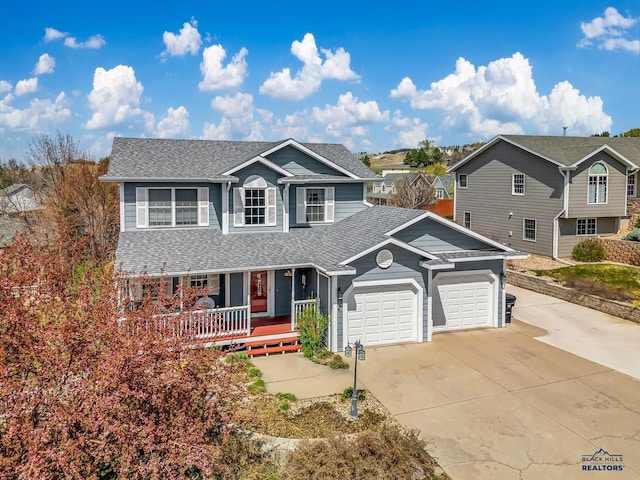 2930 Princeton Ct, Rapid City, SD 57702 - traditional-style house with covered porch, roof with shingles, concrete driveway, and a garage