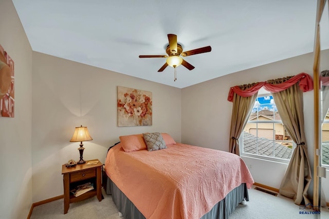 2930 Princeton Ct, Rapid City, SD 57702 - bedroom with light carpet, baseboards, and ceiling fan