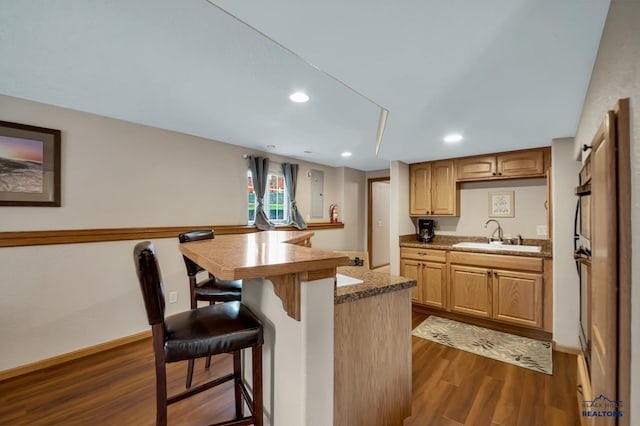2930 Princeton Ct, Rapid City, SD 57702 - kitchen featuring a sink, a kitchen bar, dark wood-type flooring, recessed lighting, and oven