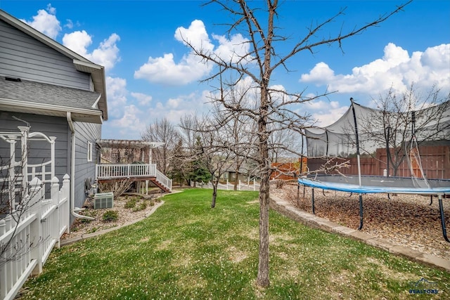 2930 Princeton Ct, Rapid City, SD 57702 - view of grassy yard with a trampoline, stairs, cooling unit, and a wooden deck