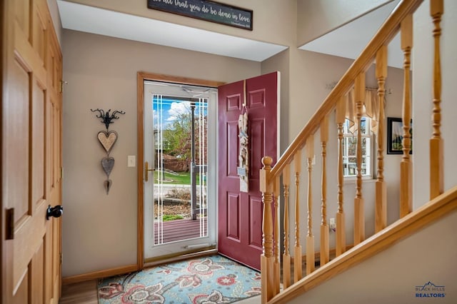 2930 Princeton Ct, Rapid City, SD 57702 - foyer featuring stairs, baseboards, and wood finished floors