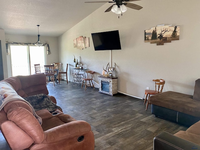 1064 Quinn Dr, Hill City, SD 57745 - living room featuring a ceiling fan, lofted ceiling, dark wood-style flooring, baseboards, and a textured ceiling
