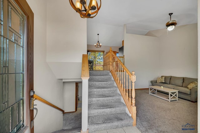 4307 Henry Ct, Rapid City, SD 57701 - stairs featuring a chandelier, plenty of natural light, tile patterned floors, and carpet floors
