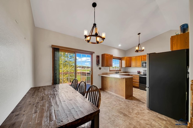 4307 Henry Ct, Rapid City, SD 57701 - kitchen with stainless steel appliances, a chandelier, vaulted ceiling, a sink, and light countertops