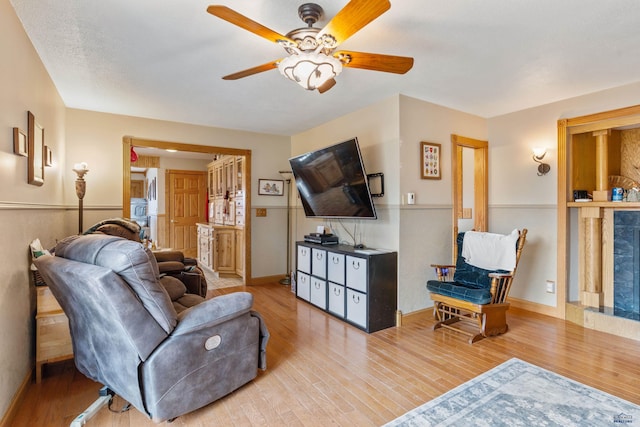 2030 12th Ave, Belle Fourche, SD 57717 - living area featuring wood finished floors, a ceiling fan, and baseboards