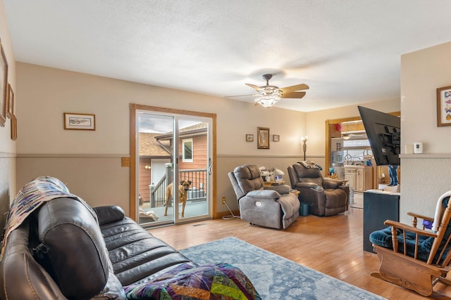 2030 12th Ave, Belle Fourche, SD 57717 - living room with healthy amount of natural light, wood-type flooring, a ceiling fan, and a textured ceiling