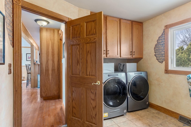 2030 12th Ave, Belle Fourche, SD 57717 - laundry room with cabinet space, washing machine and clothes dryer, and baseboards
