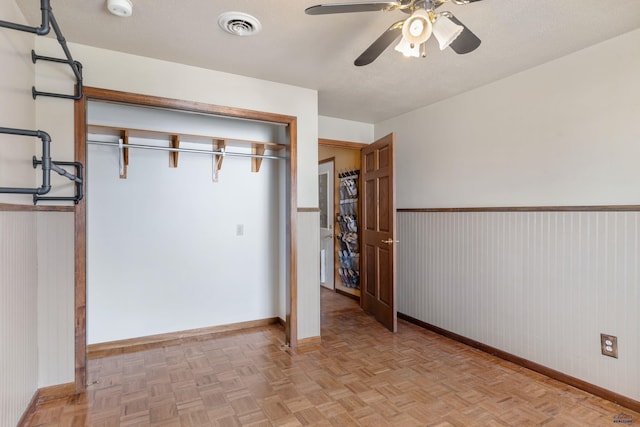 2030 12th Ave, Belle Fourche, SD 57717 - unfurnished bedroom with baseboards, a closet, and ceiling fan