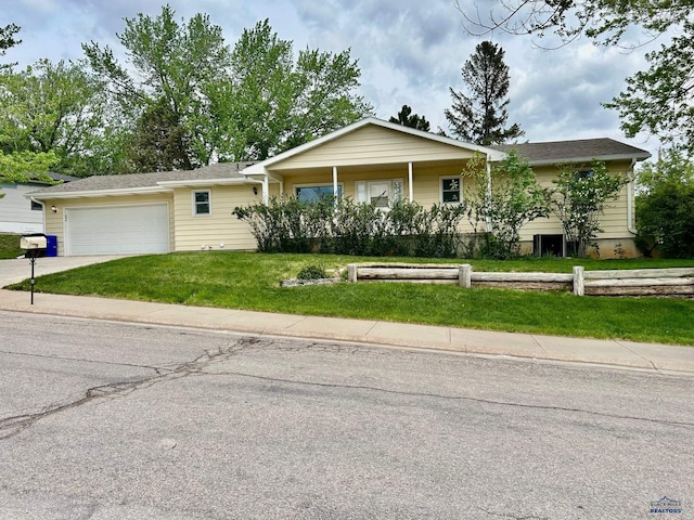 1504 Morningside Dr, Rapid City, SD 57701 - ranch-style house featuring an attached garage, a front lawn, and concrete driveway