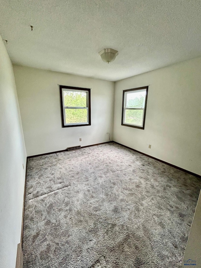 1504 Morningside Dr, Rapid City, SD 57701 - carpeted spare room featuring a textured ceiling and baseboards