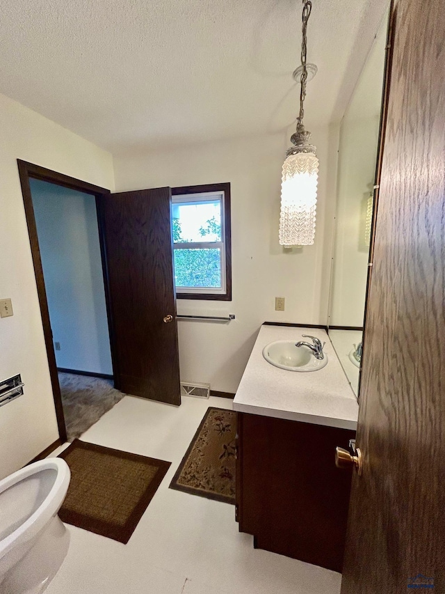 1504 Morningside Dr, Rapid City, SD 57701 - bathroom featuring vanity, a textured ceiling, and toilet