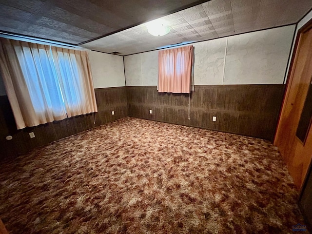 1504 Morningside Dr, Rapid City, SD 57701 - unfurnished room featuring carpet flooring, wooden walls, and wainscoting