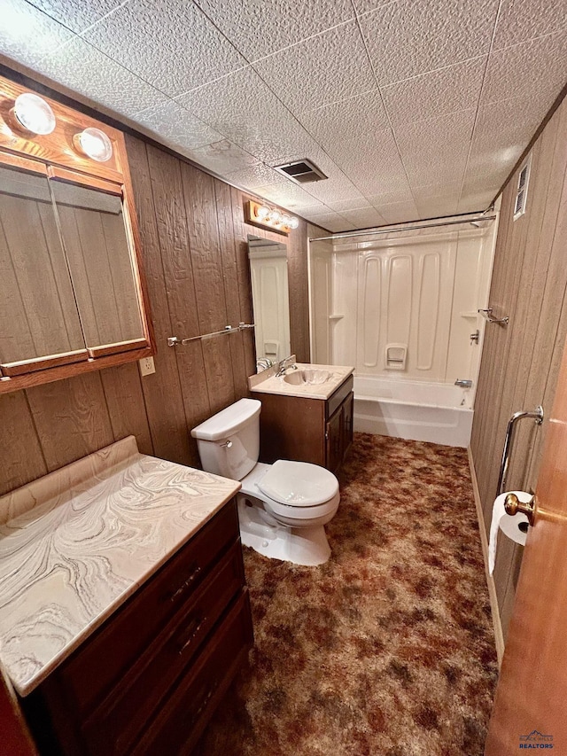 1504 Morningside Dr, Rapid City, SD 57701 - full bathroom featuring wood walls, toilet, vanity, and shower / tub combination