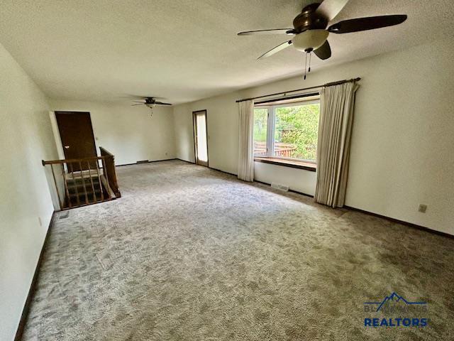 1504 Morningside Dr, Rapid City, SD 57701 - carpeted empty room featuring a ceiling fan and a textured ceiling
