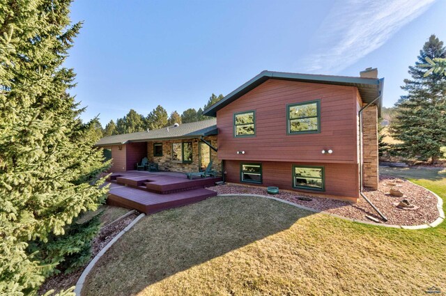 4240 Foothill Dr, Rapid City, SD 57702 - rear view of house featuring a chimney, a yard, and a wooden deck