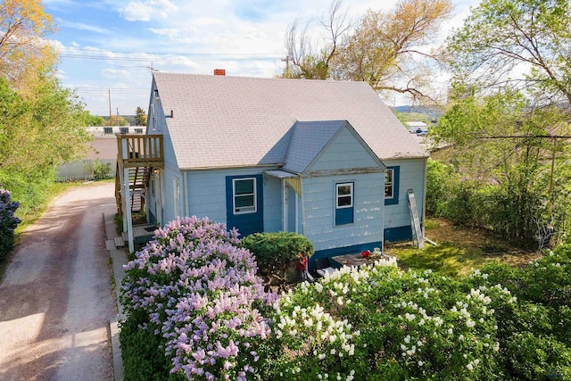 405 E Watertown, Rapid City, SD 57701 - view of front of home featuring stairs, driveway, a chimney, and roof with shingles