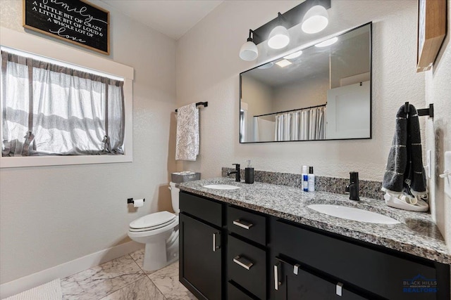 8009 Brooks Loop, Spearfish, SD 57783 - full bath featuring marble look tile flooring, baseboards, toilet, double vanity, and a shower with shower curtain