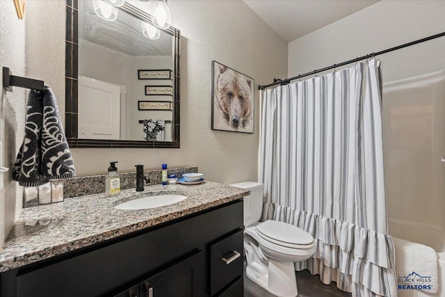 8009 Brooks Loop, Spearfish, SD 57783 - full bath featuring a textured wall, toilet, vanity, and a shower with curtain