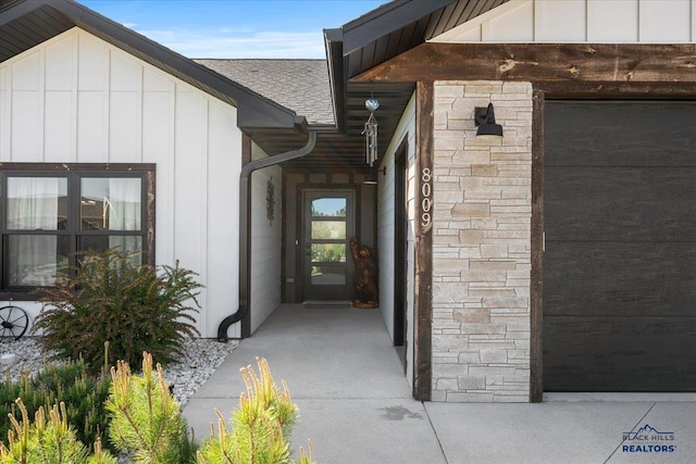 8009 Brooks Loop, Spearfish, SD 57783 - view of exterior entry with board and batten siding, stone siding, and roof with shingles