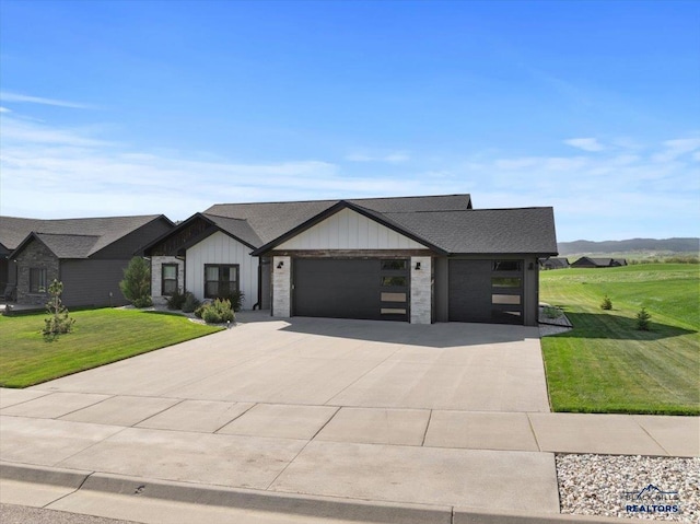 8009 Brooks Loop, Spearfish, SD 57783 - view of front of property with a front yard, a garage, driveway, board and batten siding, and roof with shingles