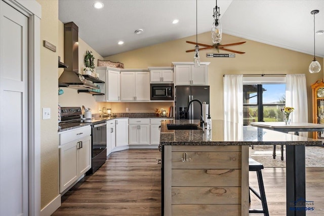 8009 Brooks Loop, Spearfish, SD 57783 - kitchen featuring black appliances, wall chimney exhaust hood, a ceiling fan, lofted ceiling, and dark wood-style floors