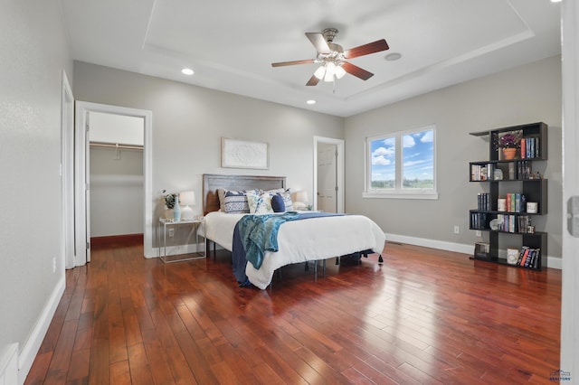 960 Nicole St, Rapid City, SD 57701 - bedroom with baseboards, wood finished floors, recessed lighting, a tray ceiling, and ceiling fan