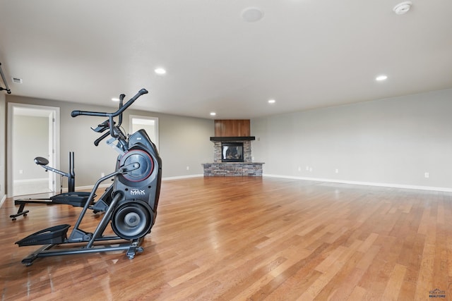 960 Nicole St, Rapid City, SD 57701 - exercise room featuring baseboards, a fireplace, recessed lighting, and light wood-style flooring