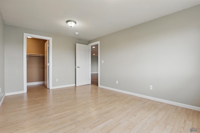 960 Nicole St, Rapid City, SD 57701 - unfurnished bedroom featuring light wood-style floors, baseboards, a spacious closet, and a closet