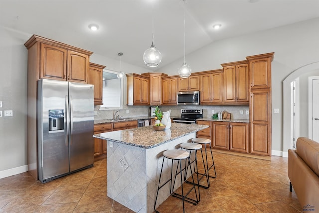 960 Nicole St, Rapid City, SD 57701 - kitchen featuring appliances with stainless steel finishes, a sink, brown cabinets, tasteful backsplash, and light stone counters