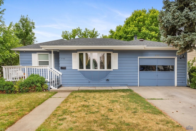 2739 W W St, Anne, Rapid City, SD 57701 - view of front of house featuring a garage, concrete driveway, and a front yard