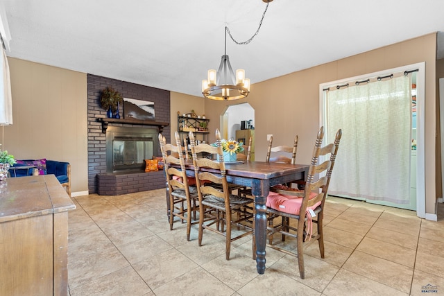 2739 W W St, Anne, Rapid City, SD 57701 - dining area featuring light tile patterned flooring, a chandelier, arched walkways, and healthy amount of natural light