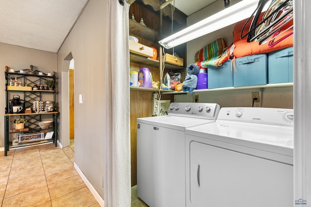 2739 W W St, Anne, Rapid City, SD 57701 - laundry area featuring independent washer and dryer, light tile patterned floors, arched walkways, and baseboards