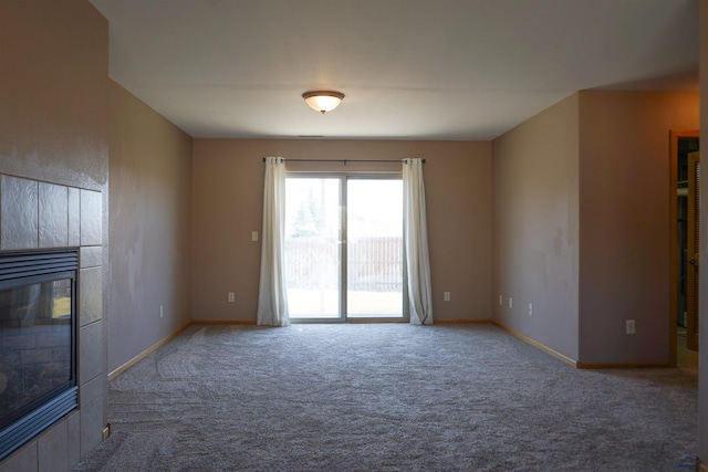 755 Field View Dr, Rapid City, SD 57701 - unfurnished living room featuring carpet flooring, a tile fireplace, and baseboards