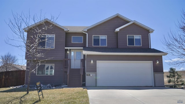 755 Field View Dr, Rapid City, SD 57701 - view of front facade with fence, driveway, and a garage