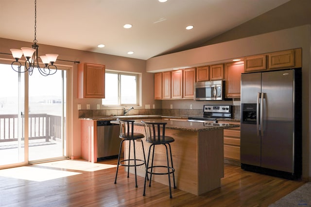 755 Field View Dr, Rapid City, SD 57701 - kitchen featuring stainless steel appliances, dark wood-type flooring, a kitchen breakfast bar, a center island, and a chandelier