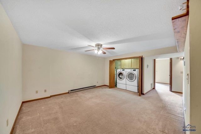 4801 Prairie Rose Pl, Rapid City, SD 57702 - laundry area featuring baseboard heating, independent washer and dryer, light colored carpet, ceiling fan, and a textured ceiling