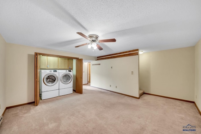 4801 Prairie Rose Pl, Rapid City, SD 57702 - laundry room with washing machine and clothes dryer, a ceiling fan, light colored carpet, a textured ceiling, and baseboards