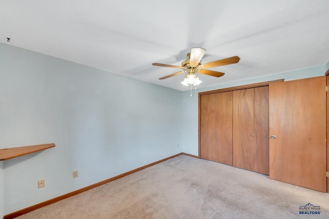 4801 Prairie Rose Pl, Rapid City, SD 57702 - unfurnished bedroom featuring light carpet, a closet, baseboards, and ceiling fan