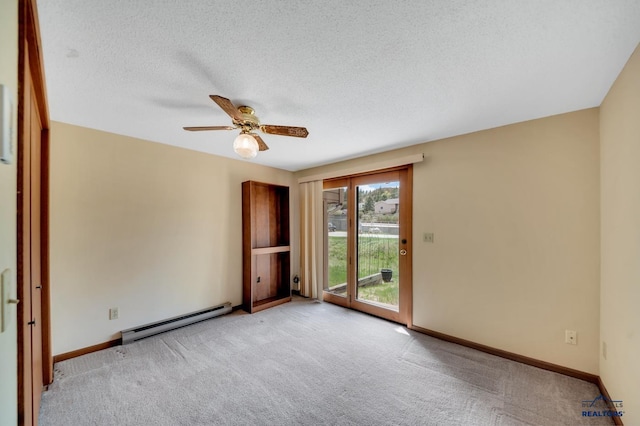 4801 Prairie Rose Pl, Rapid City, SD 57702 - empty room featuring baseboard heating, carpet flooring, a ceiling fan, and a textured ceiling