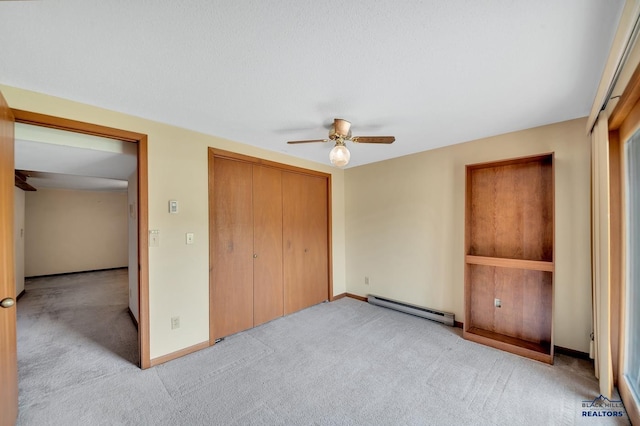 4801 Prairie Rose Pl, Rapid City, SD 57702 - unfurnished bedroom with baseboard heating, carpet floors, a closet, baseboards, and a ceiling fan