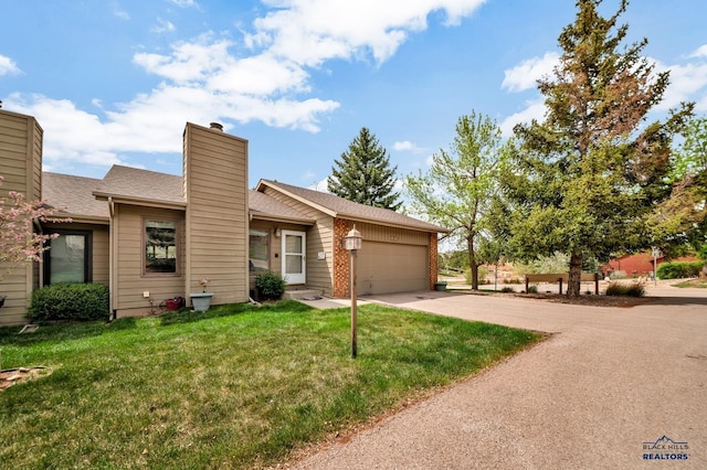 4801 Prairie Rose Pl, Rapid City, SD 57702 - view of front of home featuring an attached garage, a chimney, driveway, a front lawn, and roof with shingles