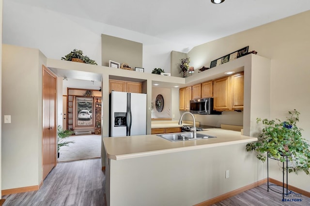 4801 Prairie Rose Pl, Rapid City, SD 57702 - kitchen with fridge with ice dispenser, stainless steel microwave, a sink, a peninsula, and baseboards