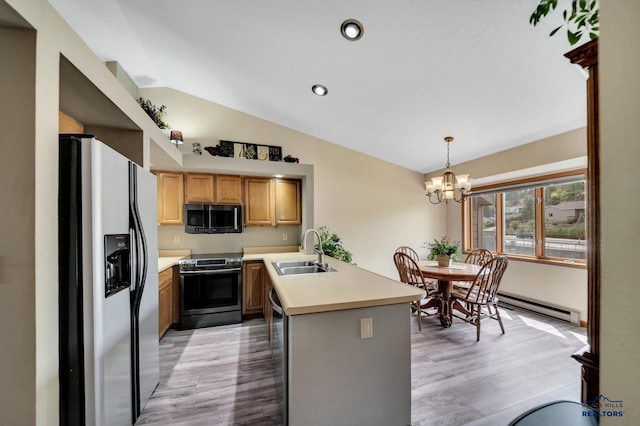 4801 Prairie Rose Pl, Rapid City, SD 57702 - kitchen with stainless steel appliances, a sink, lofted ceiling, light wood-style flooring, and a peninsula