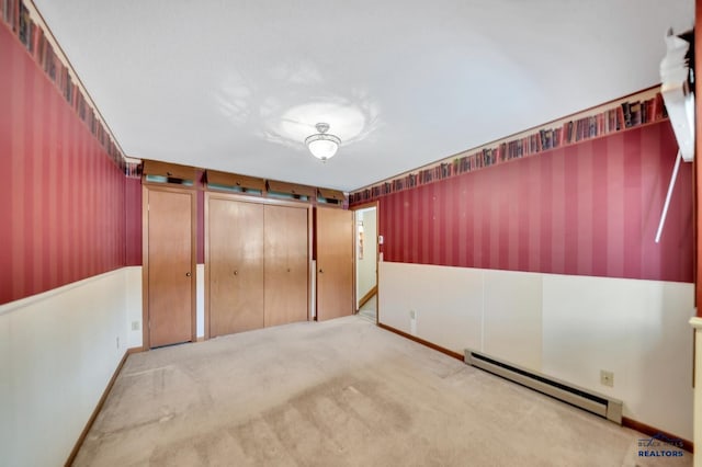 4801 Prairie Rose Pl, Rapid City, SD 57702 - unfurnished bedroom featuring a baseboard heating unit, wallpapered walls, a wainscoted wall, and carpet