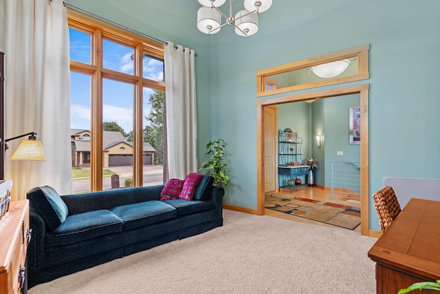 6717 Kennemer Dr, Rapid City, SD 57702 - carpeted living room with a chandelier and baseboards