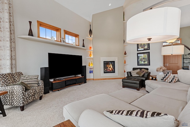 6717 Kennemer Dr, Rapid City, SD 57702 - living room featuring carpet, a glass covered fireplace, and a high ceiling