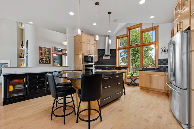 6717 Kennemer Dr, Rapid City, SD 57702 - kitchen with appliances with stainless steel finishes, island exhaust hood, decorative backsplash, light wood-style floors, and recessed lighting